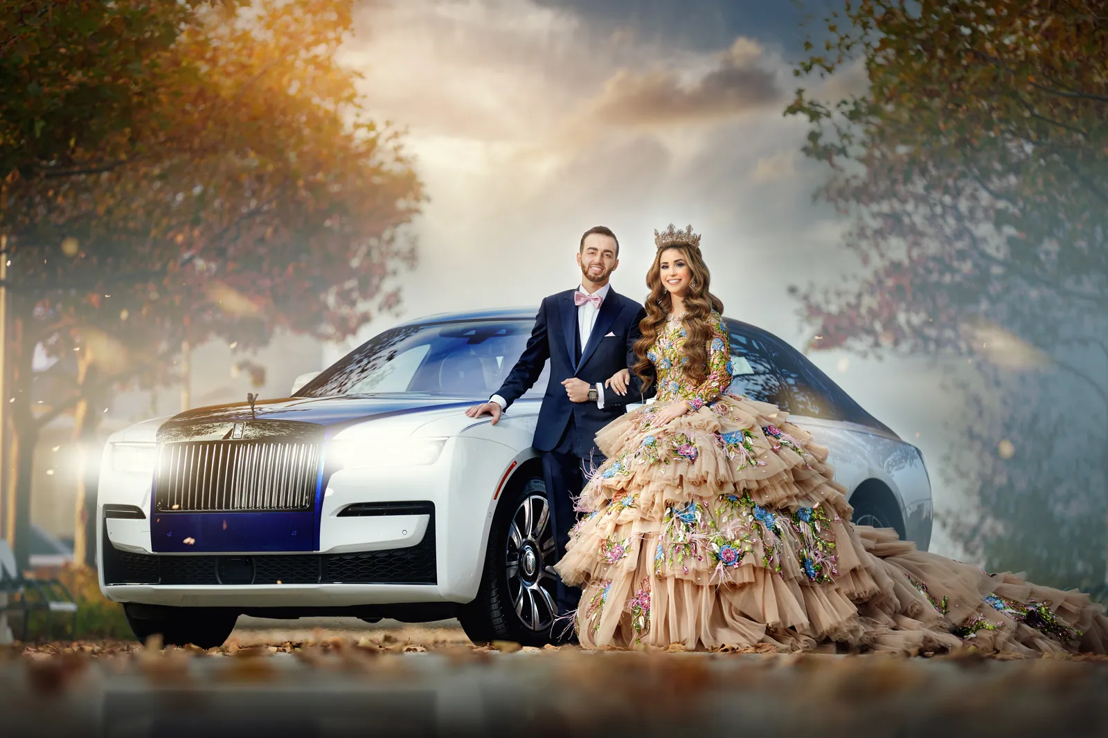 Couple with a white Rolls-Royce, bride in a floral ballgown and crown