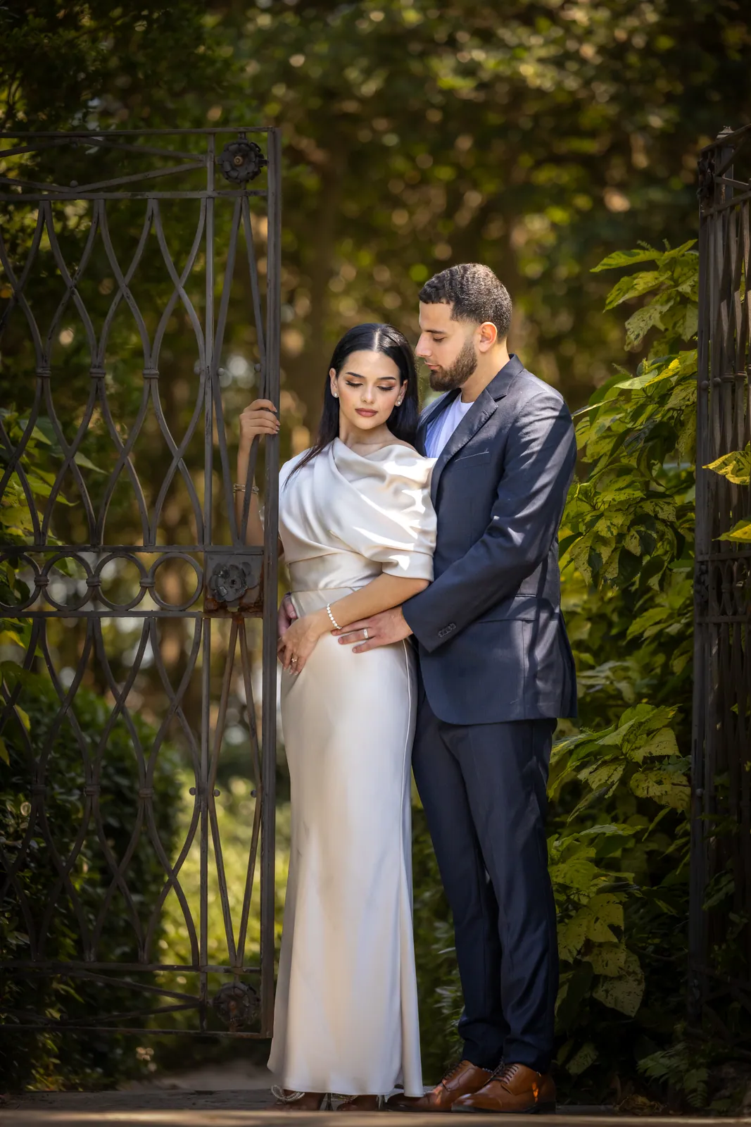Couple on a garden path, ivory gown and navy suit
