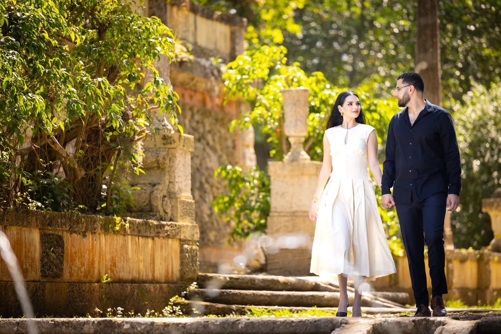Couple by a stone balustrade in a garden
