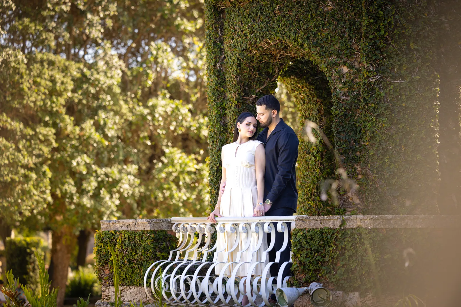 Couple beside a garden fountain and stone staircase