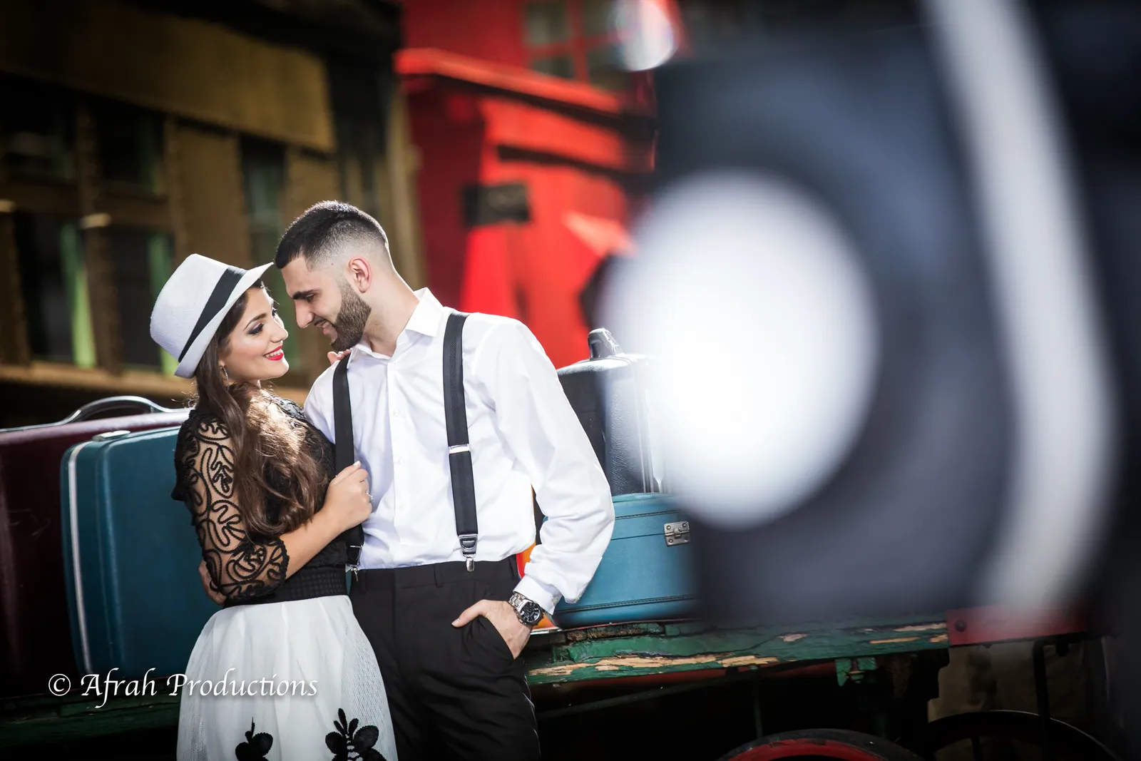 Couple in vintage dress beside a train car